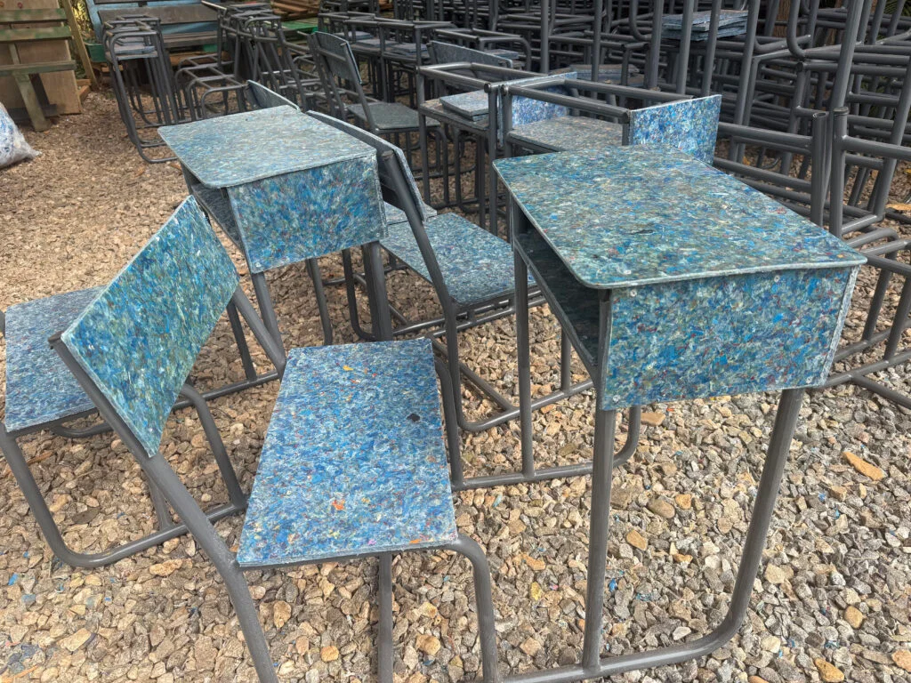 Recycled plastic school desks in a Ugandan classroom