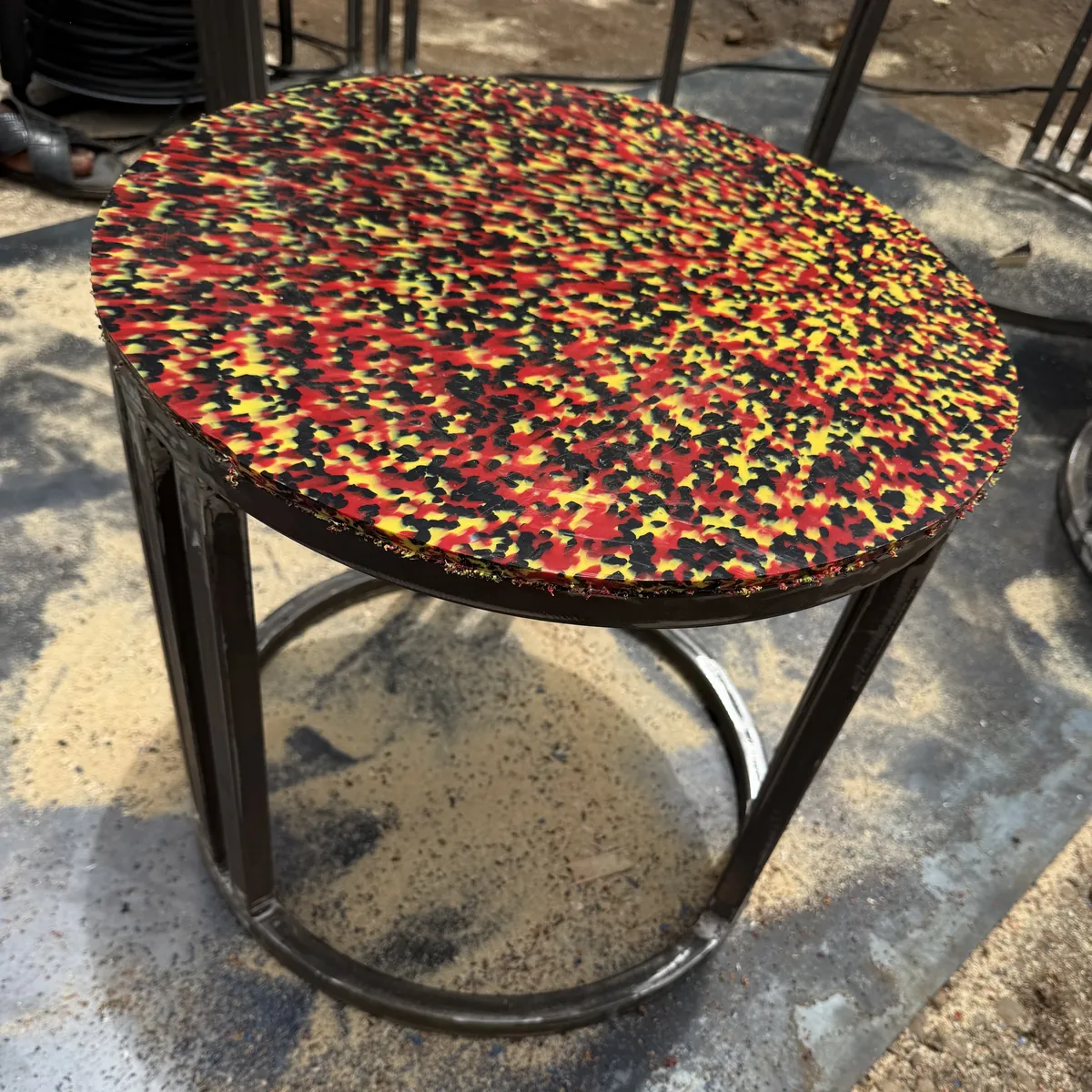 Recycled plastic side table with a speckled top
